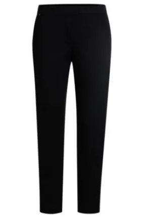 Pantalones slim fit de punto técnico elástico